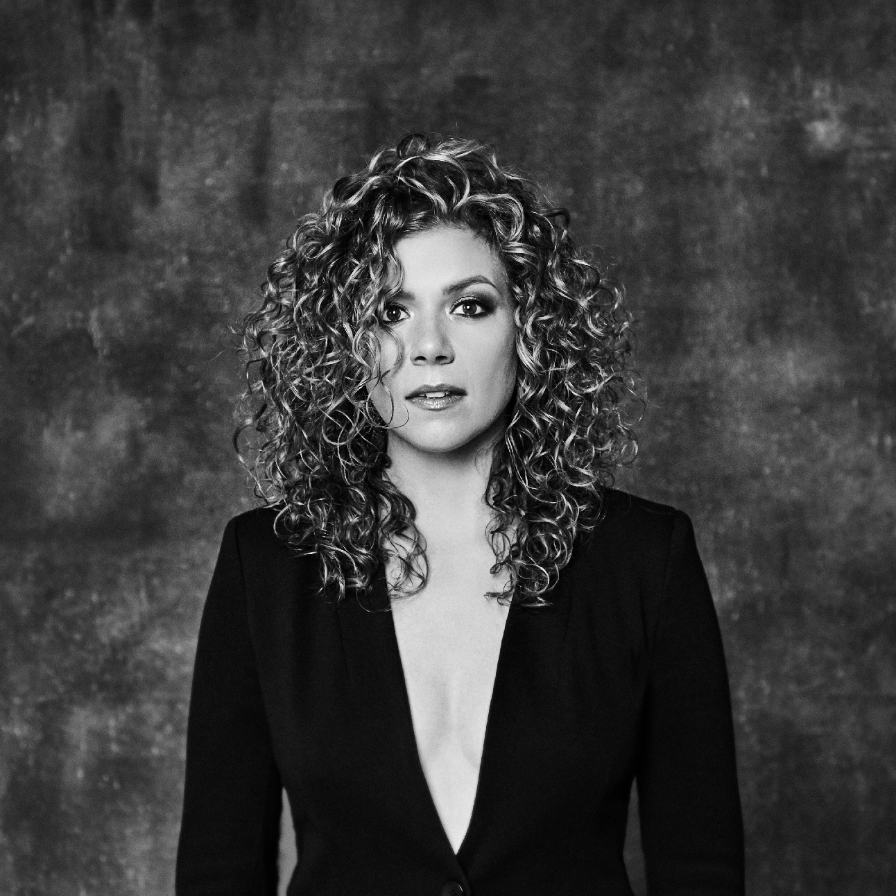 Black and white portrait, woman, curly hair, black jacket
